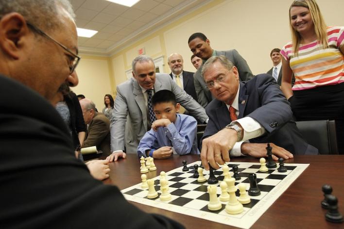 Rep. Chaka Fattah (D-PA) and Garry Kasparov watch as Jeffrey Xiong and Rep. Blaine Luetkemeyer (R-MO) make their next move at the first-ever Congressional Chess Match in Washington, DC. (Photo by Paul Morigi/AP)