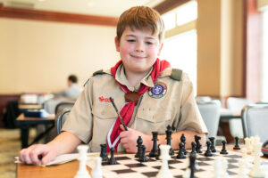Boy Scout Learning to Earn Chess Merit Badge