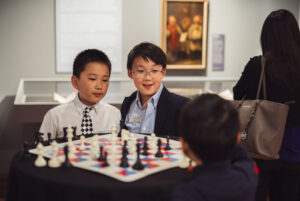 cute asian kids playing chess