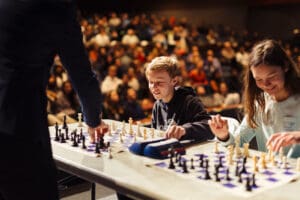chess tournament showing players and audience behind them