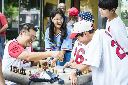 _2025 web hero - scholastic family playing chess_2_
