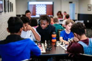 children playing chess at the STL summer scholastic grandmaster chess camp